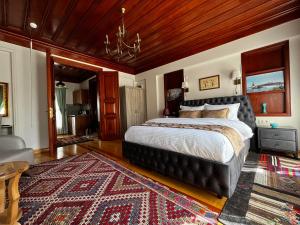 a bedroom with a large bed and a rug at Lily Mansion in Istanbul