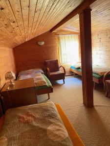 1 dormitorio con 2 camas y 1 silla en una habitación en Chata Eliška, en Příkrý