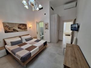 a bedroom with a bed and a television in it at Villa Dufoûr in Viareggio