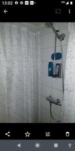 a bathroom with a shower with a shower curtain at Nardo-Trondheim in Trondheim