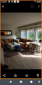 a living room with a couch and a table at Nardo-Trondheim in Trondheim