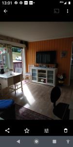 a living room with a tv and a table and a tableablish at Nardo-Trondheim in Trondheim
