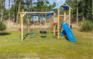 a playground with a slide and a swing at Beautiful Home In Jerup With 4 Bedrooms, Sauna And Wifi in Jerup