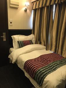 Katil atau katil-katil dalam bilik di Seasons Hotel - Causeway Bay