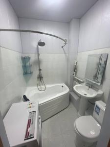 a bathroom with a tub and a toilet and a sink at Euroasia in Samarkand