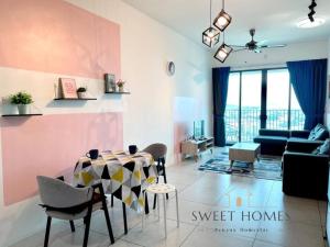 a living room with a table and a couch at Catty Suite Prai • 3BR • 2Carparks@6mins PG Bridge in Perai