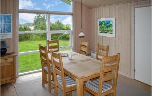 a dining room with a wooden table and chairs at 3 Bedroom Awesome Home In Sby in Nordost