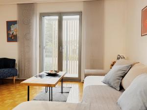 a living room with a couch and a table at Sunny House in Zambratija