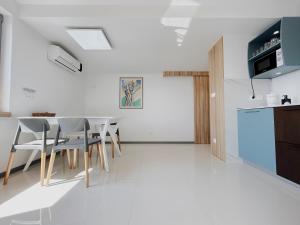 a kitchen and dining room with a table and chairs at Sunny House in Zambratija