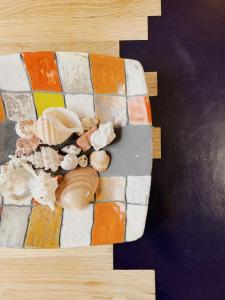 a group of seashells on a brick wall at Sunny House in Zambratija