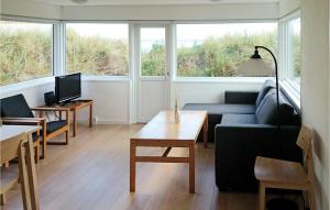 a living room with a couch and a table at Lovely Home In Strandby With Wifi in Strandby