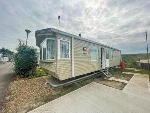 a mobile home parked on the side of a road at Lovely 6 Berth Caravan With Wifi At Steeple Bay In Essex Ref 36028b in Southminster