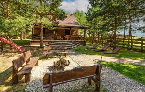 a group of benches in a park with a pavilion at Stunning Home In Pasym With House A Panoramic View in Pasym