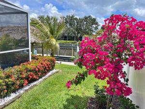 a row of flowers in front of a building at Heated pool, Family Fun, Tiki Bar, kayak, 3bd 2ba in Cape Coral