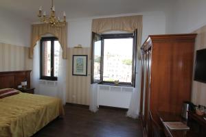 a bedroom with a bed and a window at Area Sacra Relais in Rome