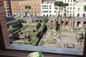 a view from a window of the ancient ruins at Area Sacra Relais in Rome +2 photos