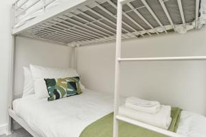 a white bunk bed in a white bedroom at The Penthouse In Bonchurch Village by Greenstay Serviced Accommodation - Stunning 3 Bed Apt With Parking & Sea Views - The Perfect Choice For Families, Small Groups & Business Travellers in Ventnor