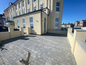 a view of a large building with aestone patio at Space Apartments - Two Bed Seafront Apartment with Off Street Parking - Windfarmer Accommodation - Flat 1 in Harwich