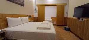 Postel nebo postele na pokoji v ubytování Kanalung Yurakucho House