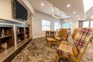 a living room with a table and chairs and a tv at Residence Inn Sacramento Rancho Cordova in Rancho Cordova