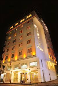 a hotel building with a sign on it at night at Demir Hotel in Diyarbakır
