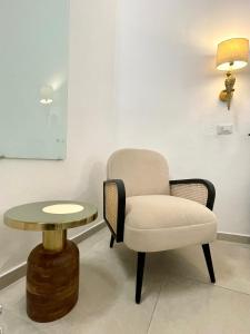 a chair and a table in a room at LG LAKE - Boutique apartments and rooms - in Brienno