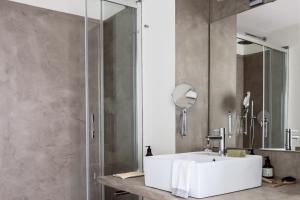 a bathroom with a white sink and a shower at Palermo Flexyrent Apartment in Milan +49 photos