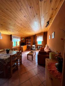 un ampio soggiorno con soffitto in legno di Casa Peppone a Pescasseroli
