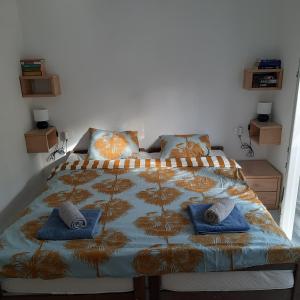 a bedroom with a bed with two pillows on it at Apartman Pelargo in Poljana