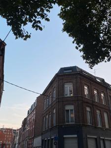a brick building on a city street at T3 lumineux en plein coeur de Moulins in Lille