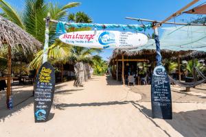 a sign for a restaurant on the beach at Feel the Waves in Arugam Bay