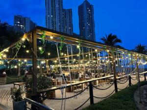 a restaurant with tables and chairs at night at Skyline @ country garden danga bay in Johor Bahru