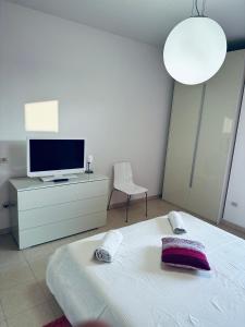 En eller flere senger på et rom på Appartamento Carino