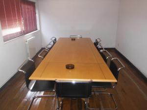 a conference room with a wooden table and chairs at Hotel Alameda in Albergaria-a-Velha