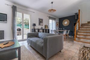 a living room with a couch and a table at Villa Tika in Béziers