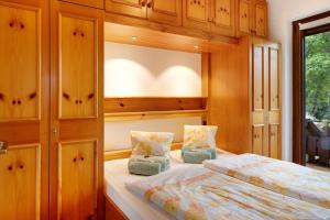 1 dormitorio con 1 cama y armarios de madera en Oskar, en Titisee-Neustadt