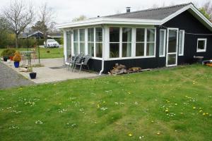 a black house with a dog sitting in the yard at (id 081) Åbakken 19 in Esbjerg