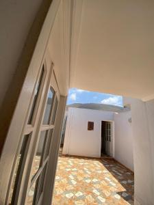 um quarto vazio com uma janela e uma parede branca em La casa de Halima em Sidi Ifni