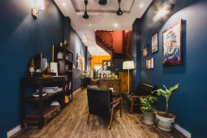 a living room with blue walls and a table and chairs at Kar-Wai's in Ho Chi Minh City