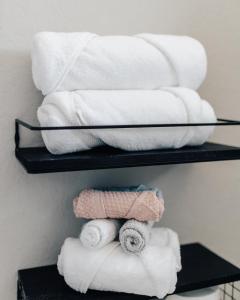a stack of towels on a shelf in a bathroom at Luxury Lovely Comfort house in San Antonio