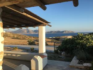 a view of the ocean from the porch of a house at John's Houses in Koufonisia