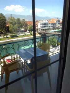 a table and chairs on a balcony with a view at Struga Riverview Hotel in Struga