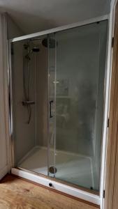 a glass shower door in a room at The Church View, Great for Contractors and groups, Easy access M1 in Markyatestreet