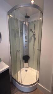 a shower with a glass enclosure in a bathroom at The Church View, Great for Contractors and groups, Easy access M1 in Markyatestreet