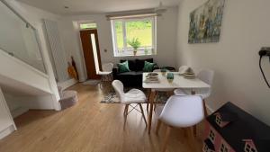 a living room with a white table and chairs at The Church View, Great for Contractors and groups, Easy access M1 in Markyatestreet