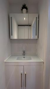 a bathroom with a sink and a mirror at The Church View, Great for Contractors and groups, Easy access M1 in Markyatestreet