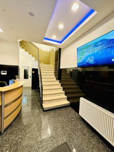 a staircase in a building with a tv on the wall at Hotel City Star in Frankfurt/Main