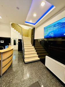 eine Treppe in einem Gebäude mit einem TV an der Wand in der Unterkunft Hotel City Star in Frankfurt am Main