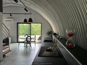 a kitchen with a table with a wine glass at VIP REFUGE in Cazillac