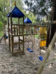 a group of playground equipment in the sand at Appartementhaus Brunsholm in Esgrus